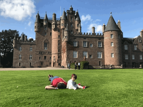 Tofig and his daughter enjoying the sun in the grounds of Glamis castle, Scotland