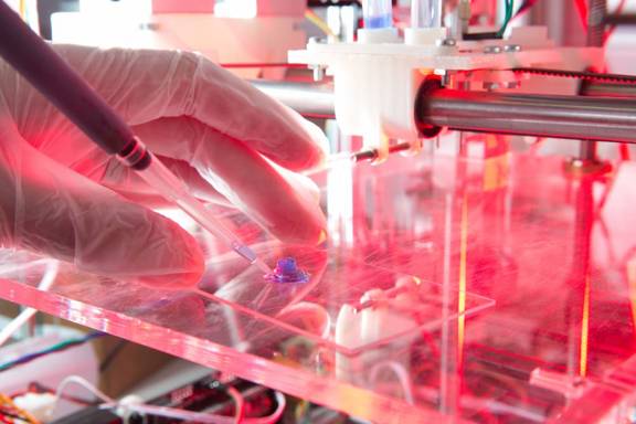 A scientist prepares a sample on a slide of glass