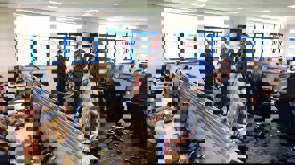 Vericall employees at work in an open-plan office