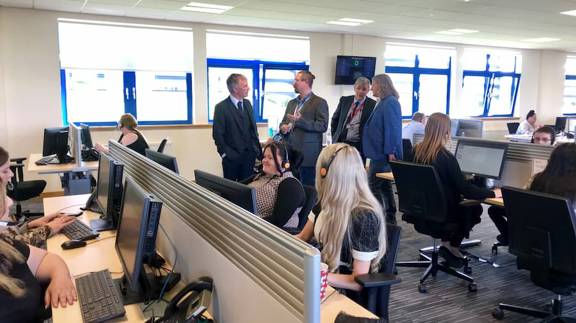 Vericall employees at work in an open-plan office