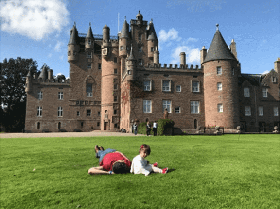 Tofig and his daughter enjoying the sun in the grounds of Glamis castle, Scotland