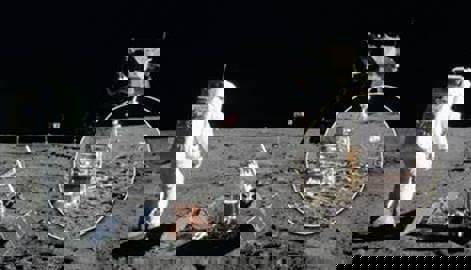 Historic shot from NASA showing some of W.L. Gore's cables in use on a moon landing. An astronaut on the moon's surface is facing towards the landing module.