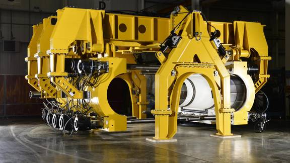 A deep-water remote vehicle which can automate structural pipeline repairs. It is a large, bright yellow machine with two large clamps that can encircle the pipeline.