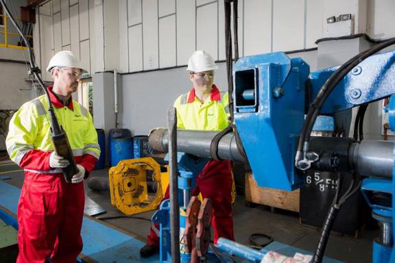 Two workers working on decommissioning equipment in Aberdeen, Scotland