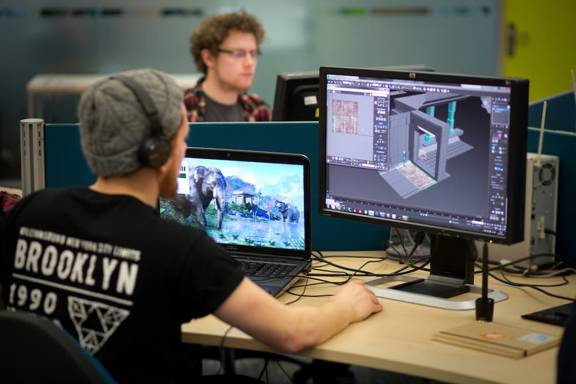 Computer games design students at Abertay University using software to design the interface for a game