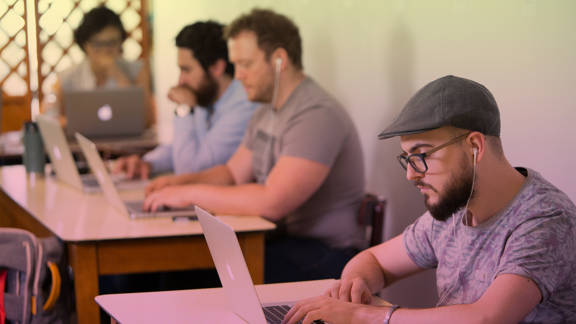 Group of people working on laptops