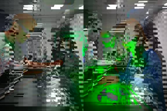 Life sciences students at Glasgow University performing an experiment using a laser