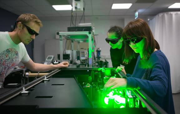 Life sciences students at Glasgow University performing an experiment using a laser