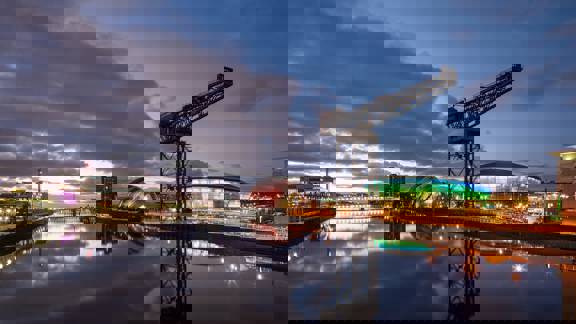 The River Clyde in Glasgow at sunset, with the Finnieston Crane, SSE hydro and SEC 'Armadillo' reflected in the still water