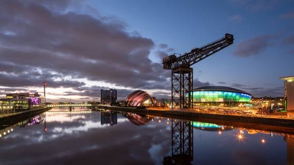 The River Clyde in Glasgow at sunset, with the Finnieston Crane, SSE hydro and SEC 'Armadillo' reflected in the still water