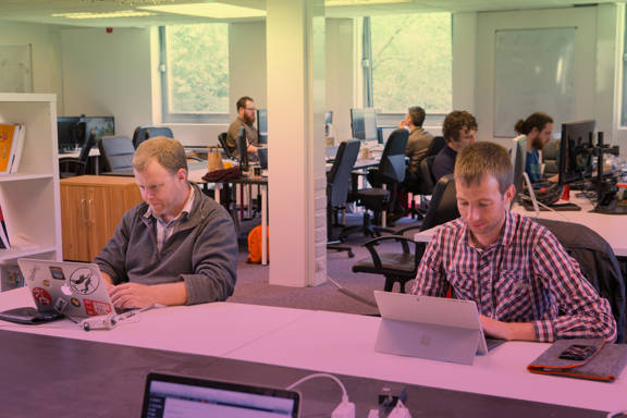 People working on laptops in Codebase's Edinburgh office