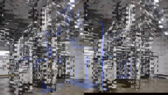 Gleaming steel pipes, tanks and vessels in a complex tangle