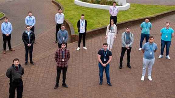 Semiconductor company Diodes staff outside in-front of company sign